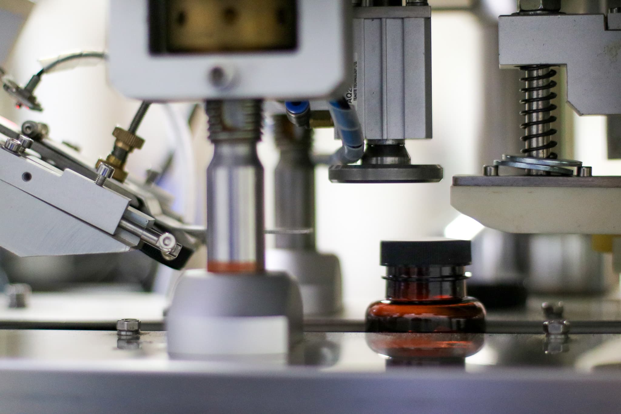Automated capping line sealing amber supplement bottles