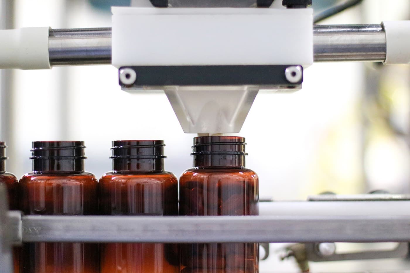Toll filling. Liquid bottles on the automated filling line